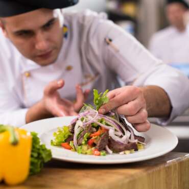cook chef decorating garnishing prepared meal