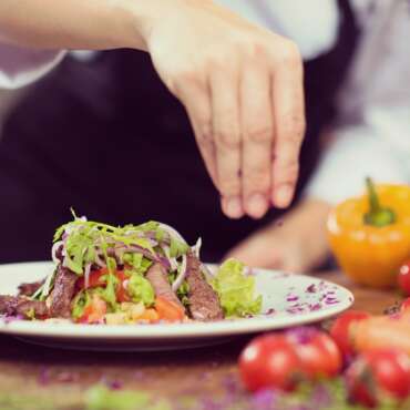 cook chef decorating garnishing prepared meal