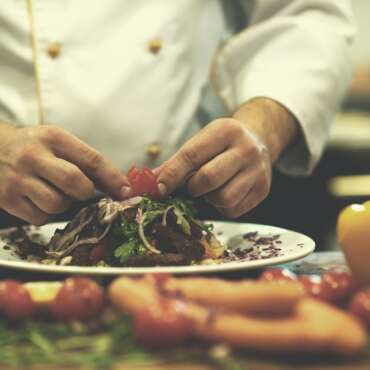cook chef decorating garnishing prepared meal