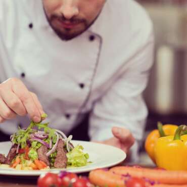 cook chef decorating garnishing prepared meal